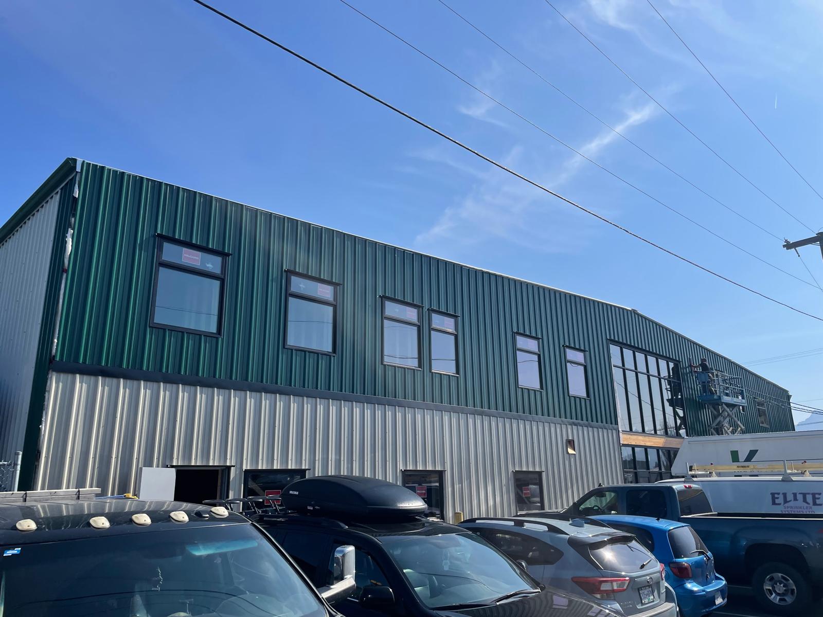 EDAPT commercial metal building with green upper and beige lower panels